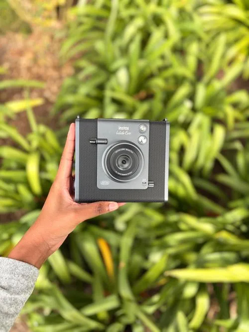 A smart imaging device held up outdoors during a field demo